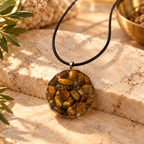 Steadfast Tiger's Eye pendant on cream marble